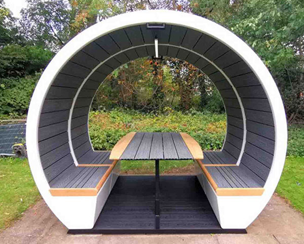 Exterior pod in garden park environment with table and benches