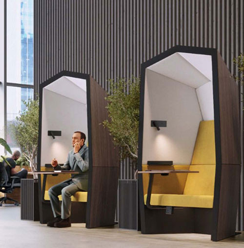 Single pods in office with man working in one